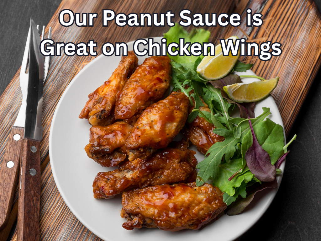 Peanut sauce chicken wings on a plate with salad and lime wedges, text overlay about peanut sauce.