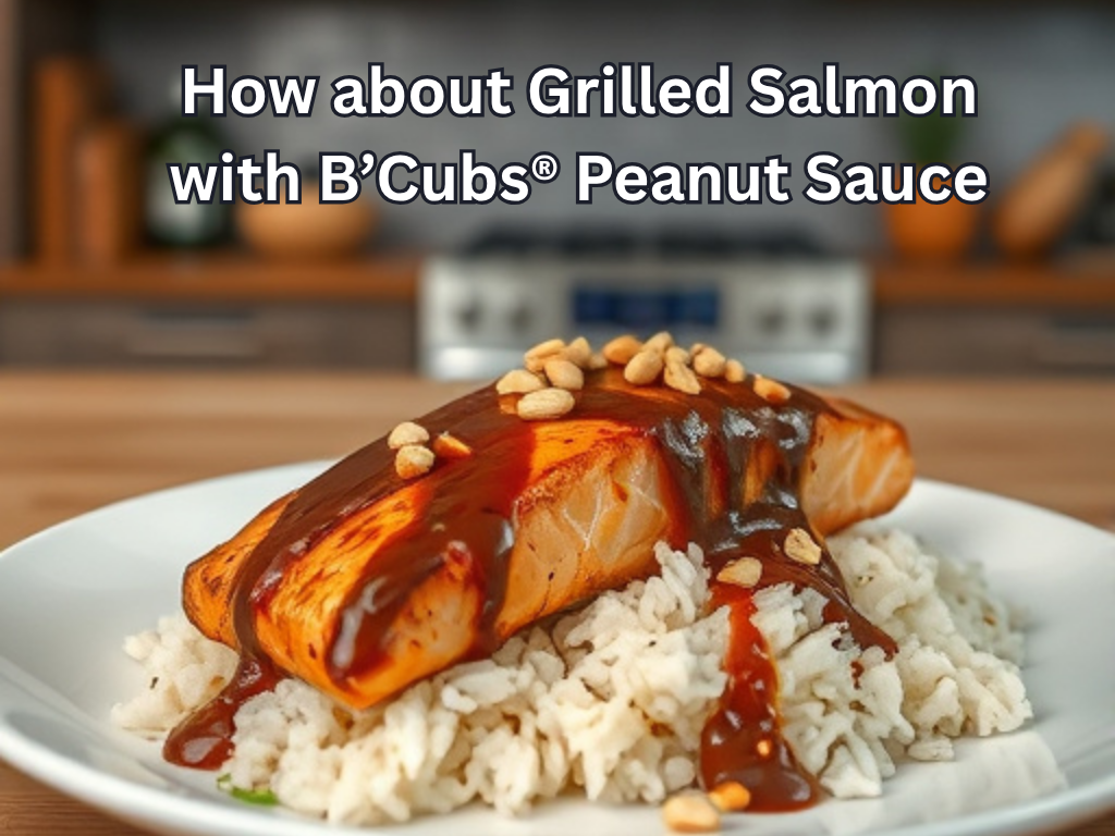 Grilled salmon with B'Cubs Peanut Sauce on a bed of rice in a kitchen setting.